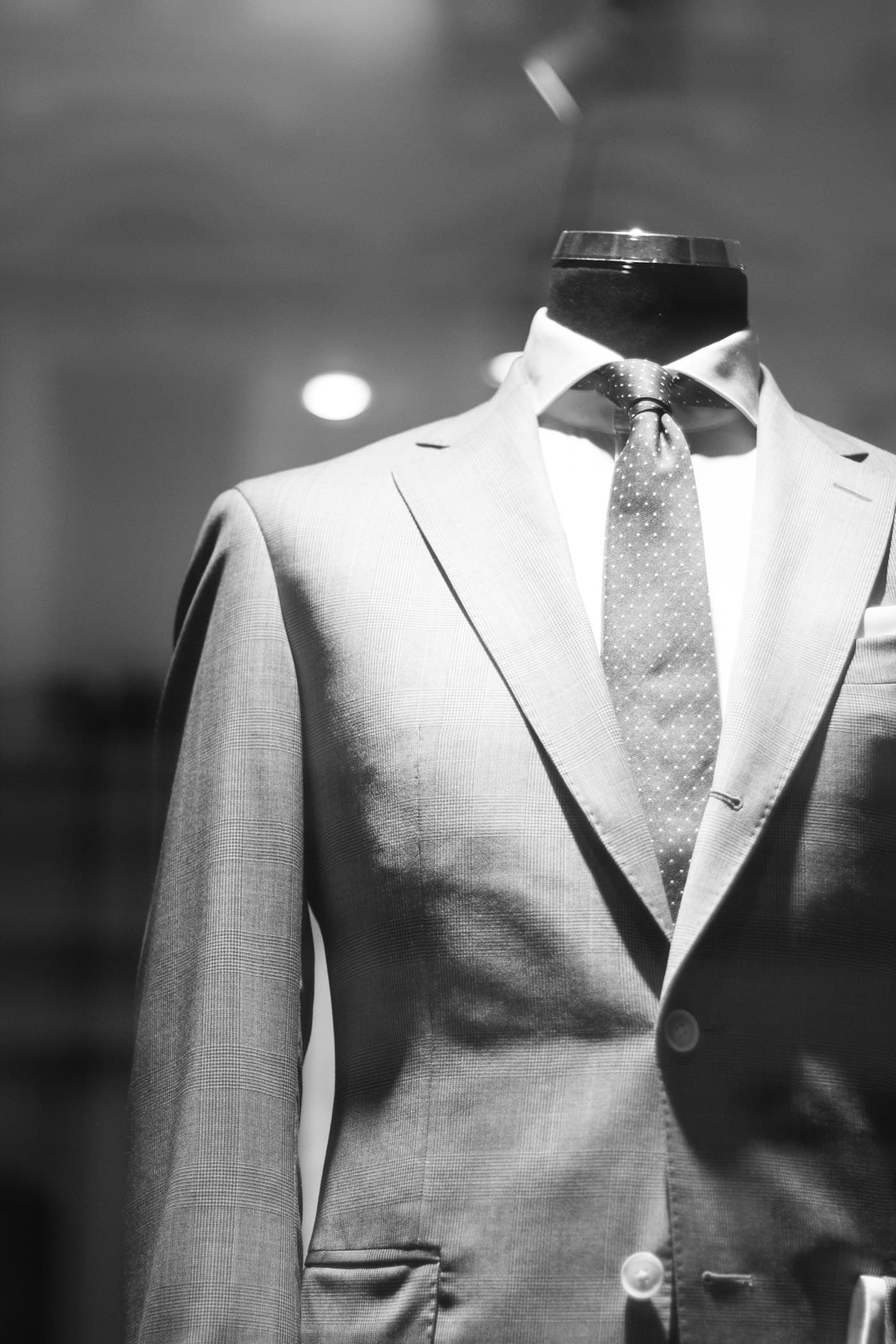 A tailored suit jacket on a dress form