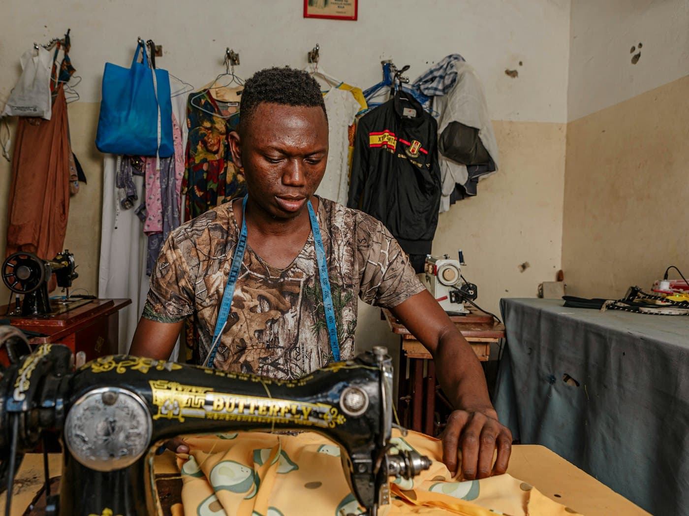 Tailor working at a sewing machine in the workroom